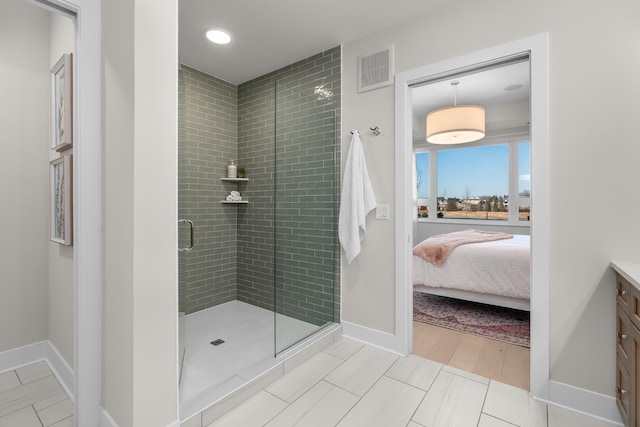 1 Hill Farm Rd Unit 107, North Oaks, MN 55127 - ensuite bathroom featuring visible vents, vanity, baseboards, connected bathroom, and a stall shower