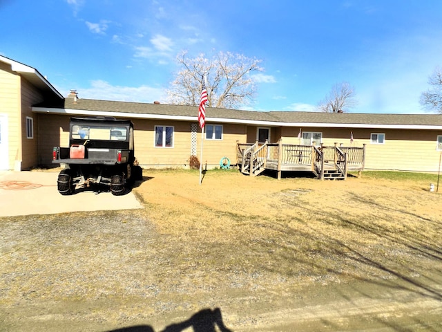 ranch-style house with a wooden deck