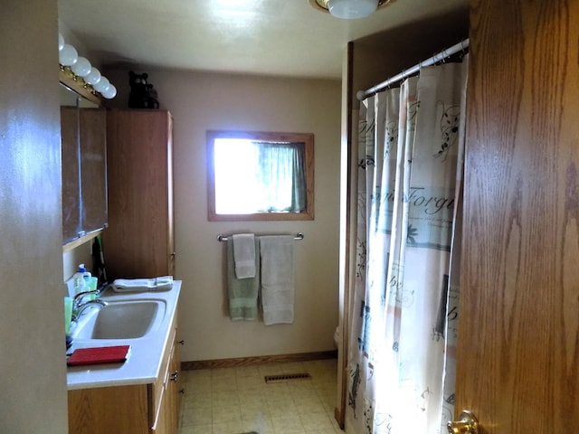 bathroom with tile flooring, vanity, and toilet