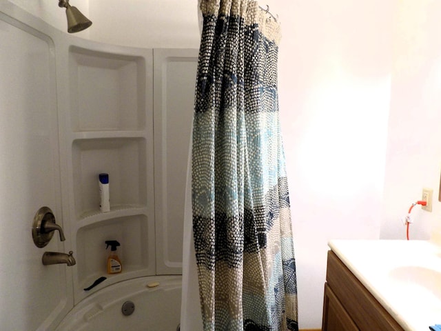 bathroom featuring vanity and shower / bathtub combination with curtain