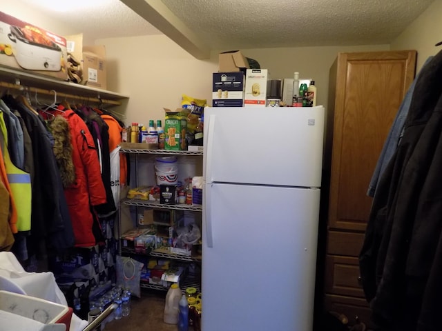 interior space featuring white refrigerator and a textured ceiling