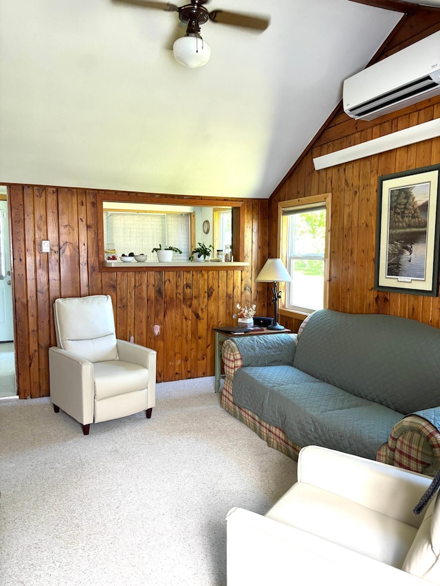 living area with ceiling fan, wooden walls, carpet floors, vaulted ceiling, and a wall mounted air conditioner