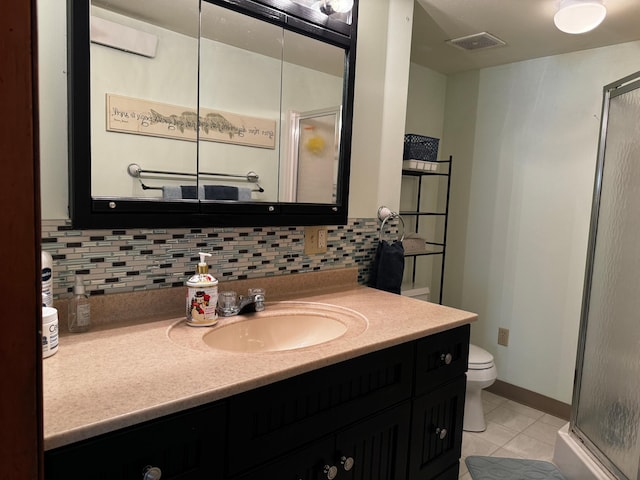 bathroom with tasteful backsplash, a stall shower, vanity, and visible vents