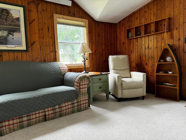 living area featuring carpet floors, vaulted ceiling, and wooden walls