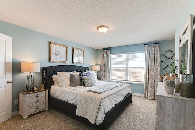 bedroom with light carpet and a textured ceiling