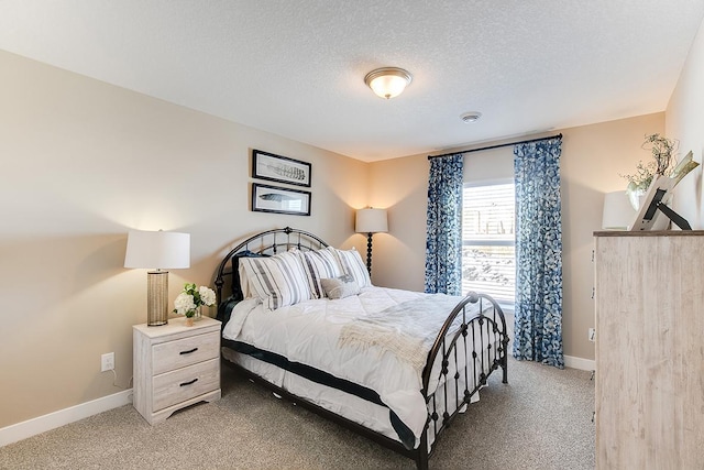 carpeted bedroom featuring a textured ceiling