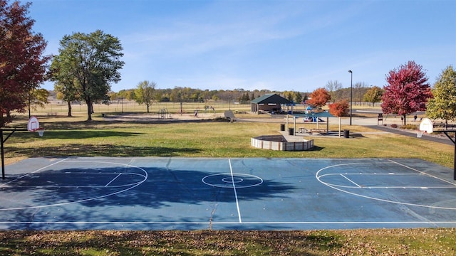 view of basketball court featuring a lawn