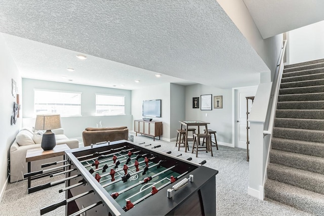 playroom with a textured ceiling and carpet flooring