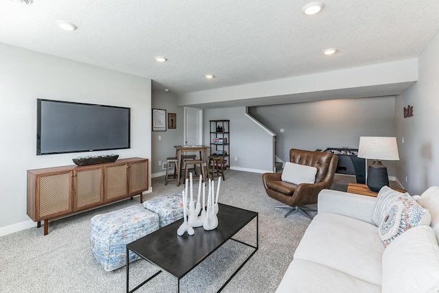 living room with light carpet and a textured ceiling