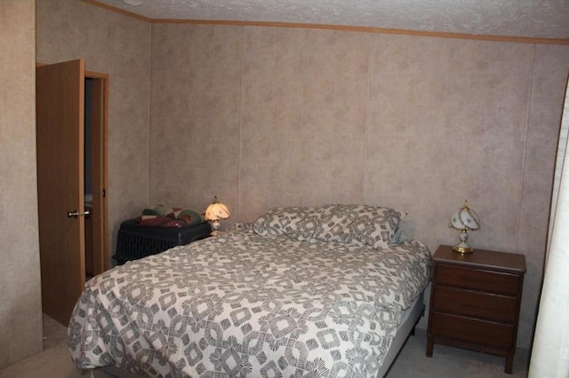 bedroom featuring a textured ceiling and crown molding