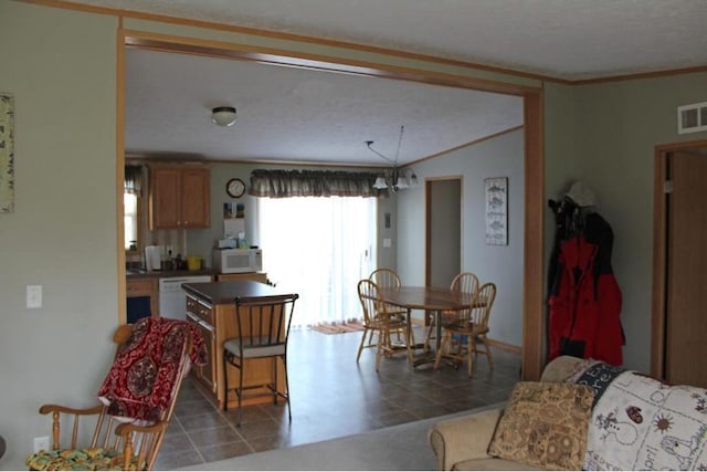 interior space featuring a textured ceiling and ornamental molding