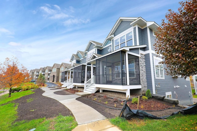 rear view of property with a sunroom