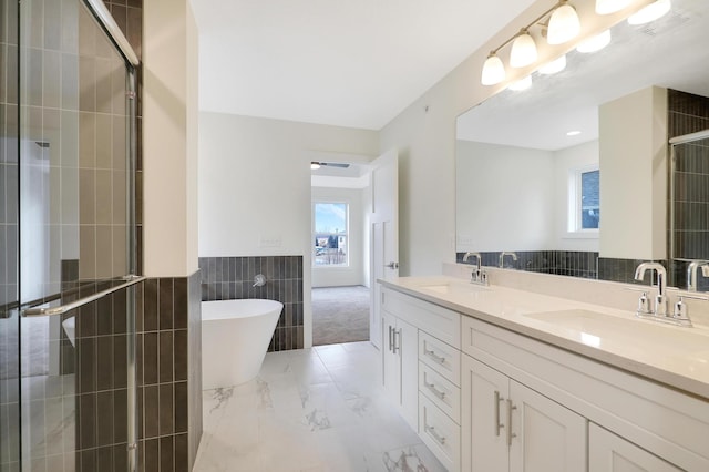 bathroom with tile walls, dual sinks, oversized vanity, tile floors, and plus walk in shower