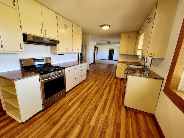 kitchen featuring sink, light hardwood / wood-style floors, white cabinetry, and stainless steel range with gas stovetop