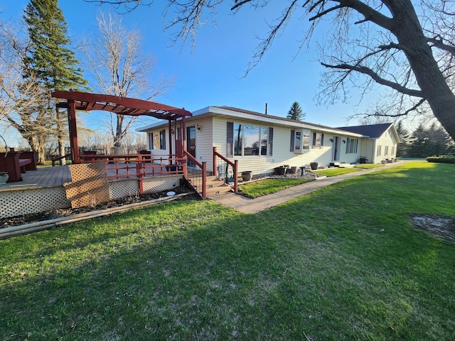 back of property featuring a pergola, a lawn, and a deck