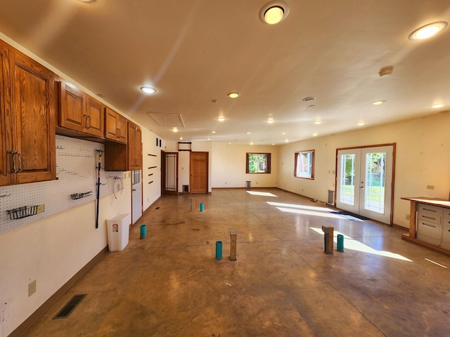 interior space with backsplash and french doors