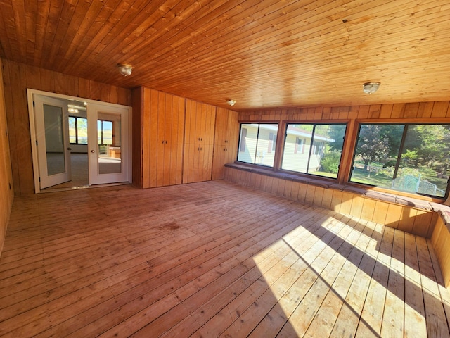 unfurnished sunroom featuring lofted ceiling and wood ceiling