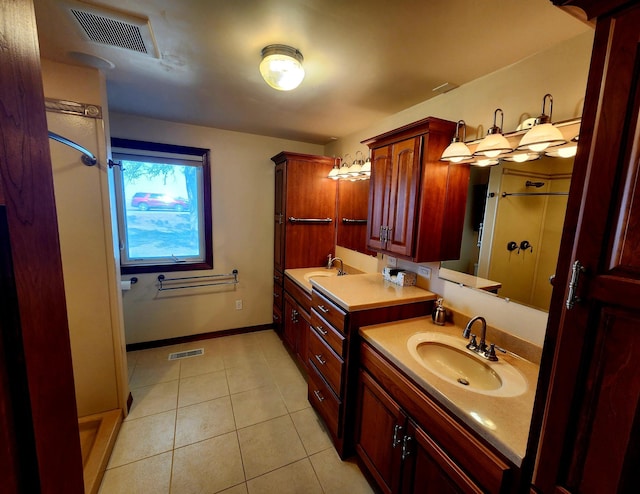 bathroom with tile patterned floors, vanity, and walk in shower