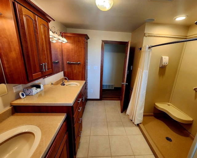 bathroom featuring tile patterned flooring and vanity