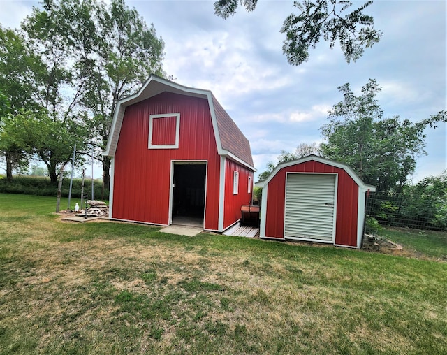 view of outbuilding featuring a lawn