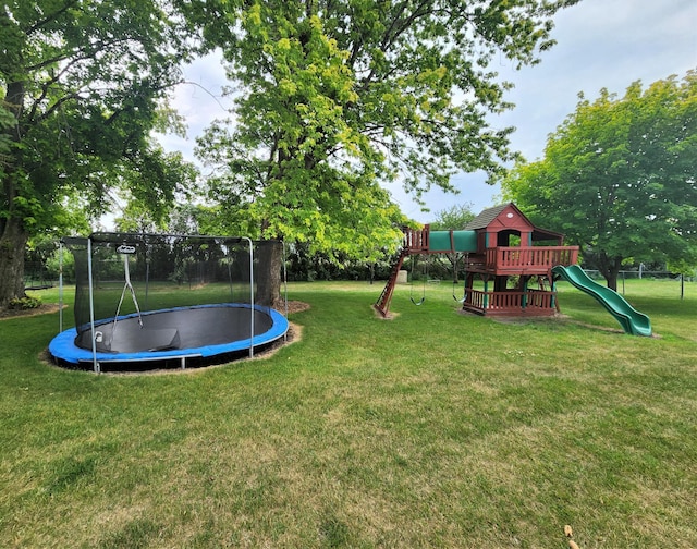 view of yard with a playground and a trampoline