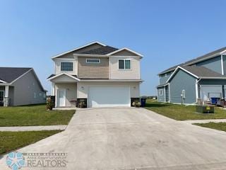 view of front facade featuring a front yard and a garage