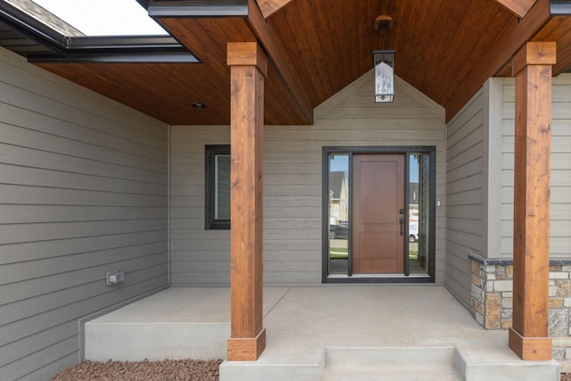 view of exterior entry with covered porch