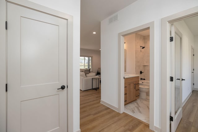 hall with light hardwood / wood-style flooring