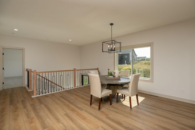 dining room featuring light hardwood / wood-style flooring and a chandelier