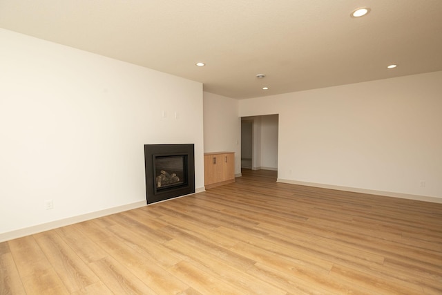 unfurnished living room featuring light wood-type flooring