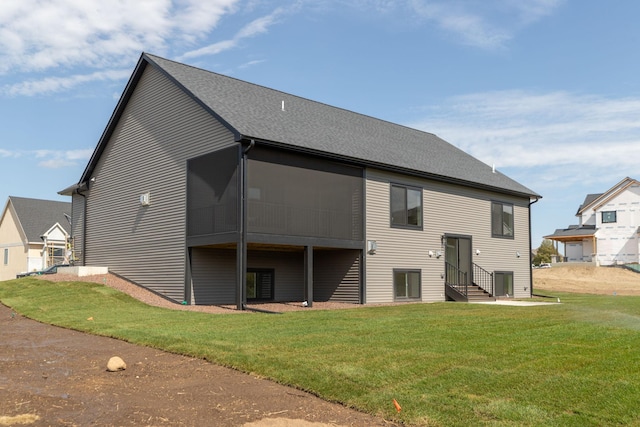 rear view of property with a lawn