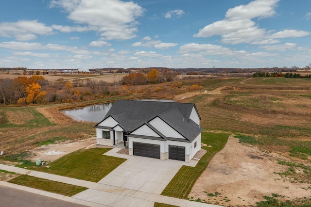 birds eye view of property with a water view and a rural view