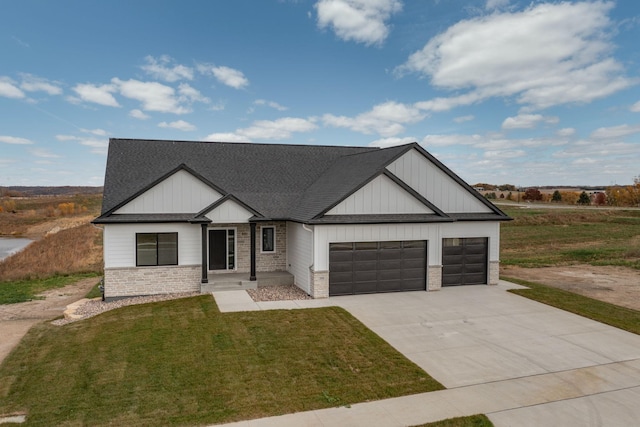 view of front of home featuring a front yard and a garage