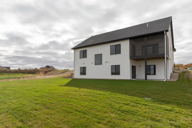 back of house with a lawn