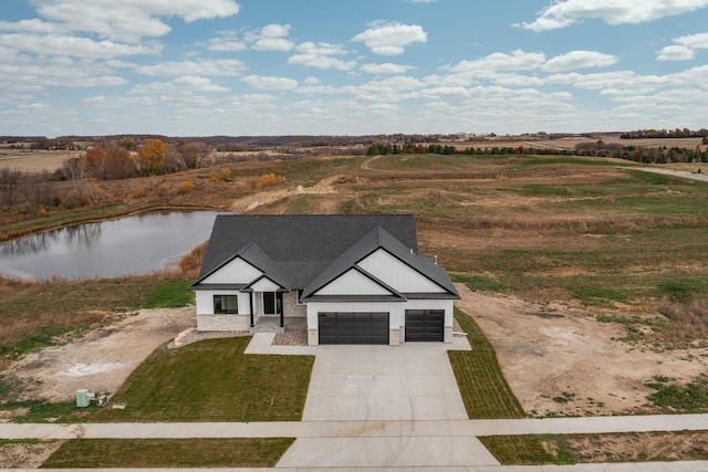 drone / aerial view with a water view and a rural view