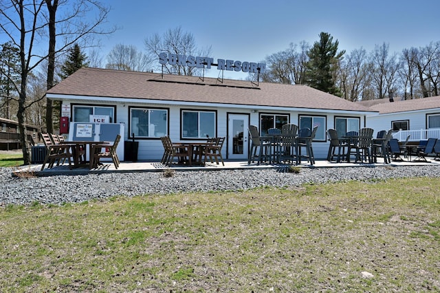 rear view of property featuring a patio, a yard, and central air condition unit