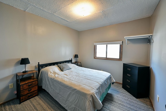 carpeted bedroom featuring a textured ceiling