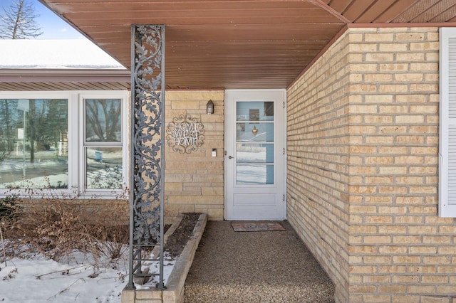 view of snow covered property entrance