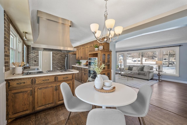 dining room featuring lofted ceiling, a chandelier, and dark hardwood / wood-style floors