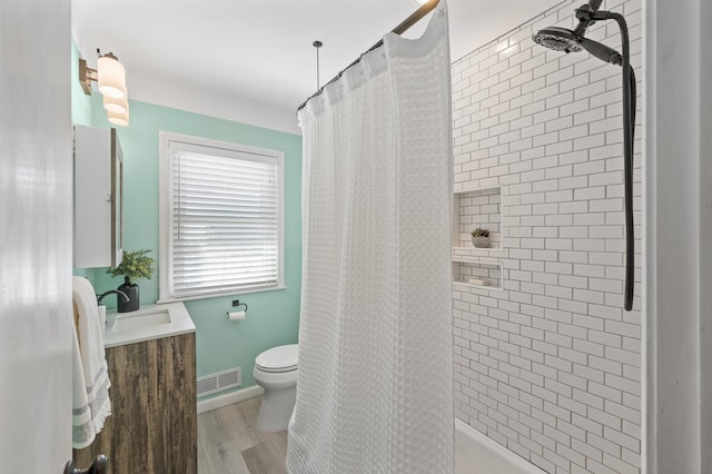 bathroom featuring toilet, vanity, and wood-type flooring