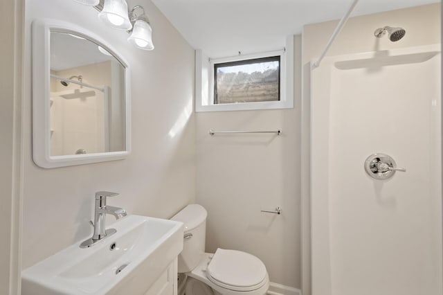 bathroom with sink, toilet, and walk in shower