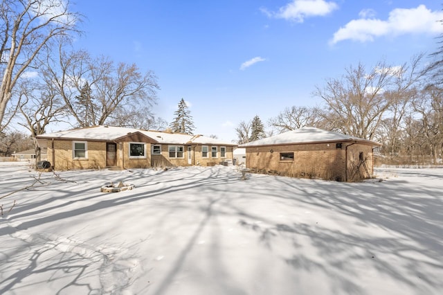 view of snow covered rear of property