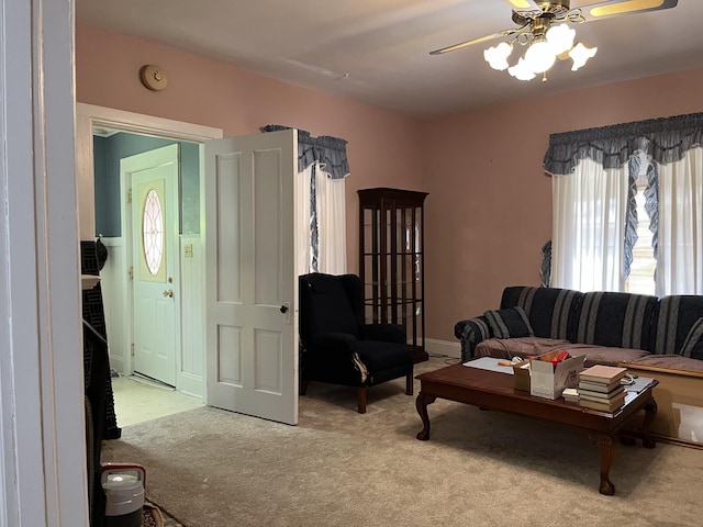 living room with ceiling fan and carpet flooring