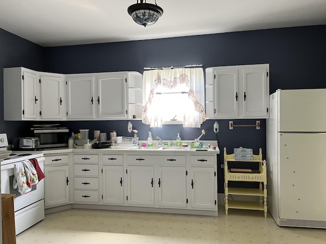 kitchen featuring light tile floors, white cabinets, white appliances, and sink