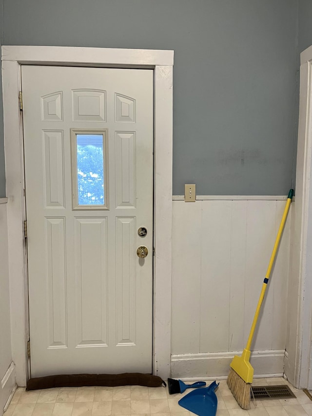 doorway featuring light tile floors