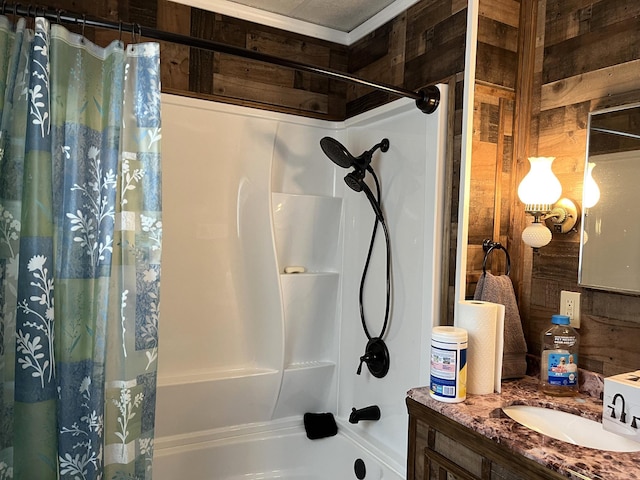 bathroom with wood walls, shower / tub combo, and vanity