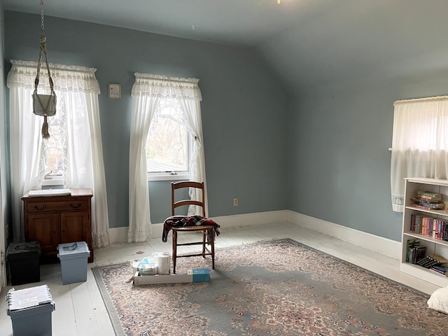 sitting room with lofted ceiling