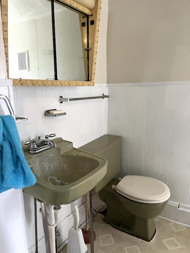 bathroom with toilet and tile flooring