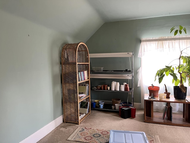 sitting room featuring vaulted ceiling and carpet