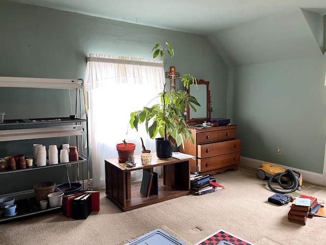 interior space featuring carpet flooring and vaulted ceiling